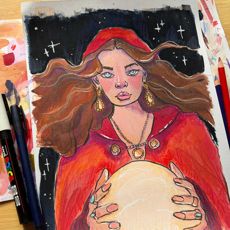 Colorful drawing of a woman holding a crystal ball on a wooden surface with art supplies.